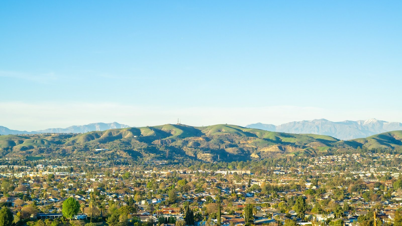 Aerial view of an Orange County, California neighborhood with hills in the background